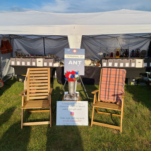 deck chairs and tables set up at an antique show